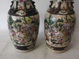 two vases sitting side by side on a table