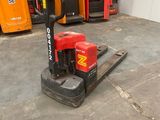 a picture of a forklift in a warehouse with other forklifts in the background