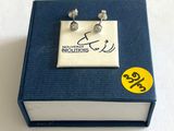 une petite boîte sur laquelle est posée une paire de boucles d'oreilles