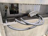 a power cord connected to an electrical outlet on a wall