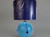 a blue lamp with a blue shade on top of it