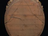 a wooden plaque with carvings on it on a black background