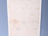 an old piece of paper hanging on the wall in a room