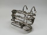 a metal wire holder with a bunch of hooks on it