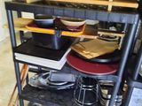 shelves with pots and pans stacked on them in a kitchen