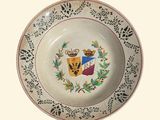 a plate with a coat of arms and a crown on it