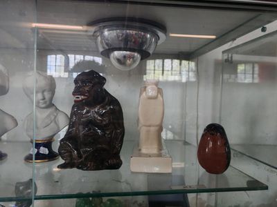 a glass display case with a variety of figurines in it