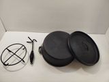 two black pots and a wire on a white surface