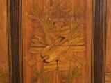 a wooden cabinet with a carving of a bird and flowers on it
