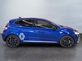 a blue car parked in a garage with a white wall behind it