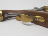 an old rifle with brass fittings on a white background