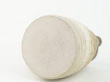 a close up of a white vase on a white surface