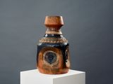 a vase that is sitting on top of a white pedestal