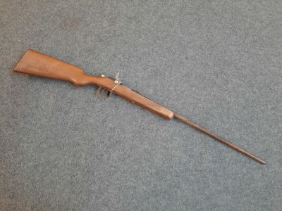 a rifle that is laying on the floor