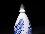 an image of a white and blue vase sitting on top of a table
