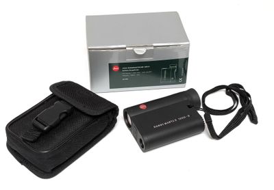 an image of a camera with a case and a charger