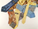 several different colored ties laid out on a white surface