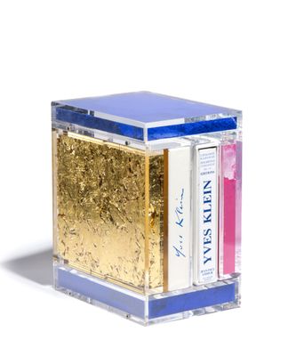 a gold and blue box with books inside of it