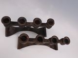 pair of antique cast iron pipe holders on a white background