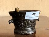 a small metal vase with a tag on it on a table