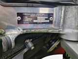 a close up of a motorcycle engine with a number plate on it