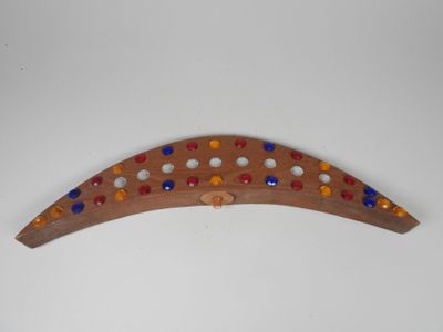 a small wooden object with colorful beads on it