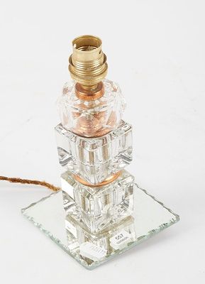 a glass lamp that is on top of a glass plate