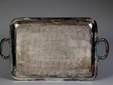silver tray with handles and handles on a white surface