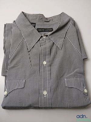 a close up of a black and white checkered shirt on a table