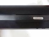a black speaker sitting on top of a white table