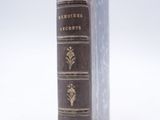 an old book that is sitting on a white surface