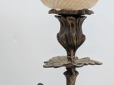 a candle that has a bird on it on a branch