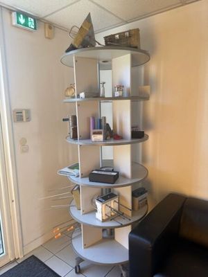 a room with a black couch and a white book shelf