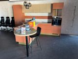 a kitchen with a table and chairs in the middle of the room