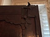 a black bird sitting on top of a wooden door