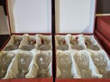 two open boxes with wine bottles in them on a table