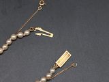 pearl necklace with a gold clasp and a pearl bead necklace with a gold clasp