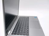 a silver laptop computer sitting on top of a white table