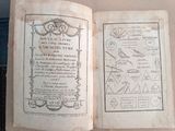 an old book that is open on a table