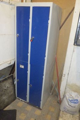 a blue locker in the corner of a room
