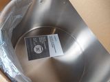 a metal pan in a cardboard box with a label on it