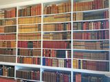 many books that are on the shelves in the room