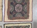 several different rugs are laid out on the floor with a person standing next to them