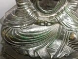 a silver statue of a woman with a crown on it ' s head