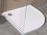 a white shower with a glass door and a shower head