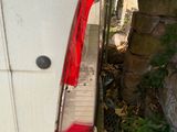 a white van that is parked next to a stone wall