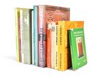 a lot of books that are stacked on top of each other