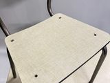 an image of a metal chair with a wooden seat on top of a table