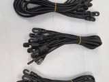 three pairs of black electrical wires on a white surface