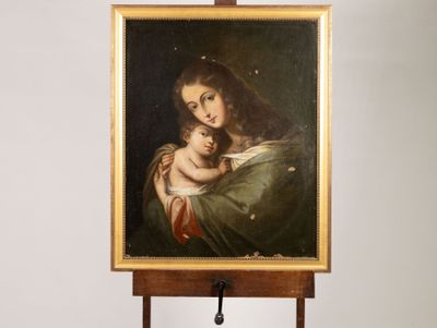an oil painting of a woman holding a baby on a easel